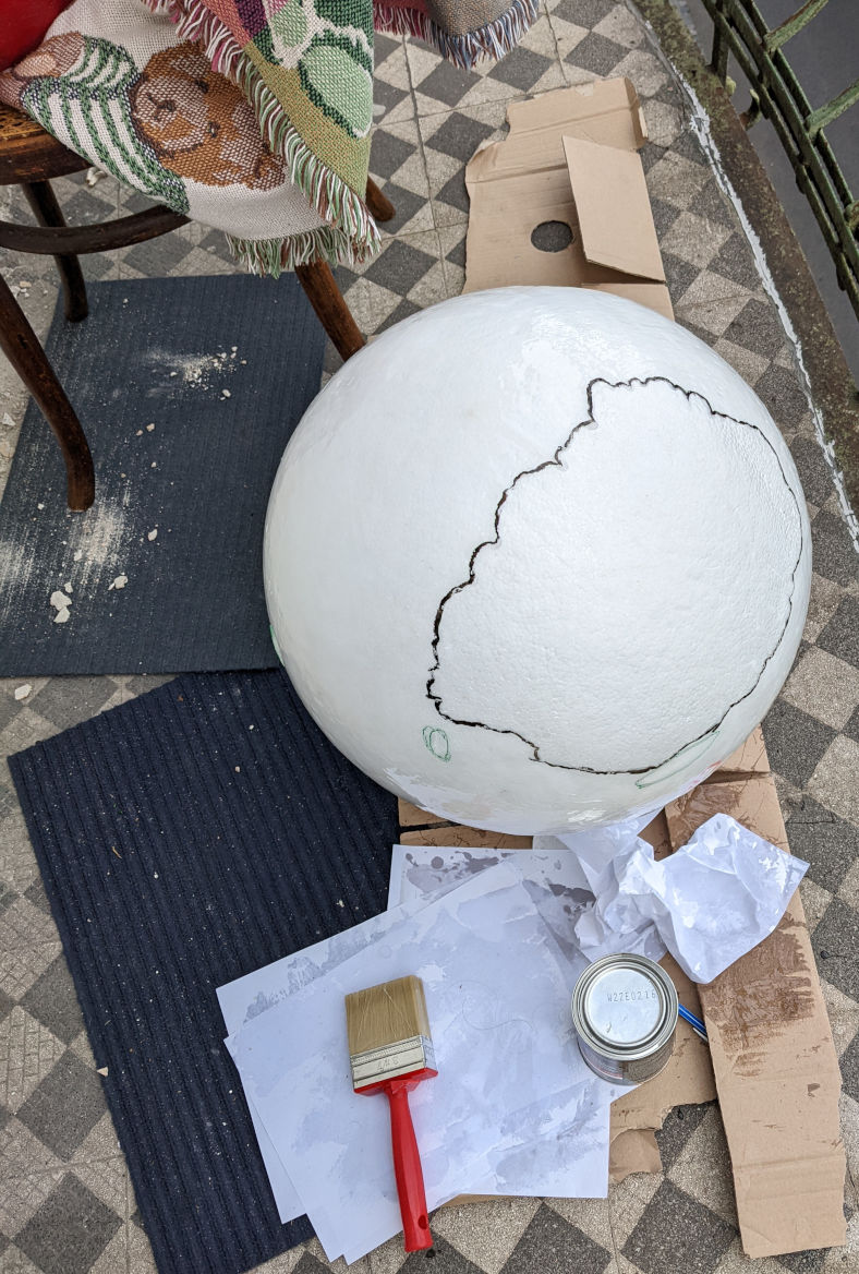 Applying a liquid rubber coating to the styrofoam ball.